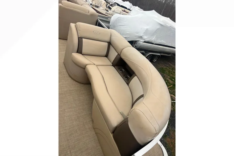 Slide: The Image of 2019 Harris Cruiser 210 boat interior with beige seating and cup holders. - 21