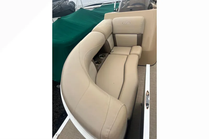 Slide: The Image of 2019 Harris Cruiser 210 boat with beige seating and cup holders. - 22