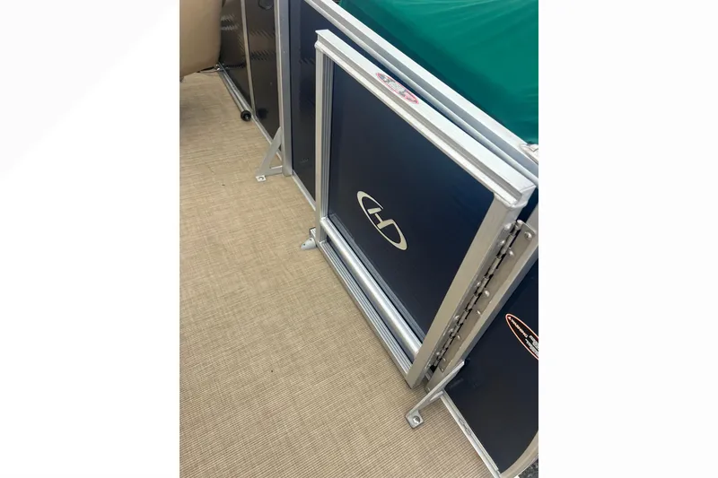 Slide: The Image of 2019 Harris Cruiser 210 boat interior with blue panel and silver frame. - 27
