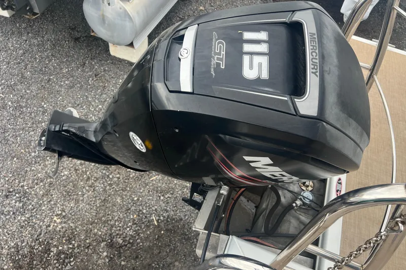 Slide: The Image of Mercury 115 outboard motor on 2019 Harris Cruiser 210 boat, parked on gravel. - 28