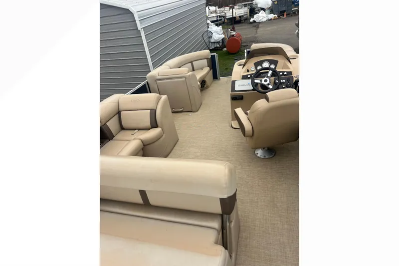Slide: The Image of 2019 Harris Cruiser 210 pontoon boat interior with beige seating and steering console. - 29