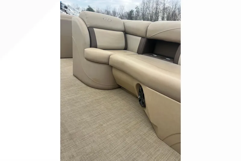 Slide: The Image of 2019 Harris Cruiser 210 boat interior with beige seating and carpeted flooring. - 34