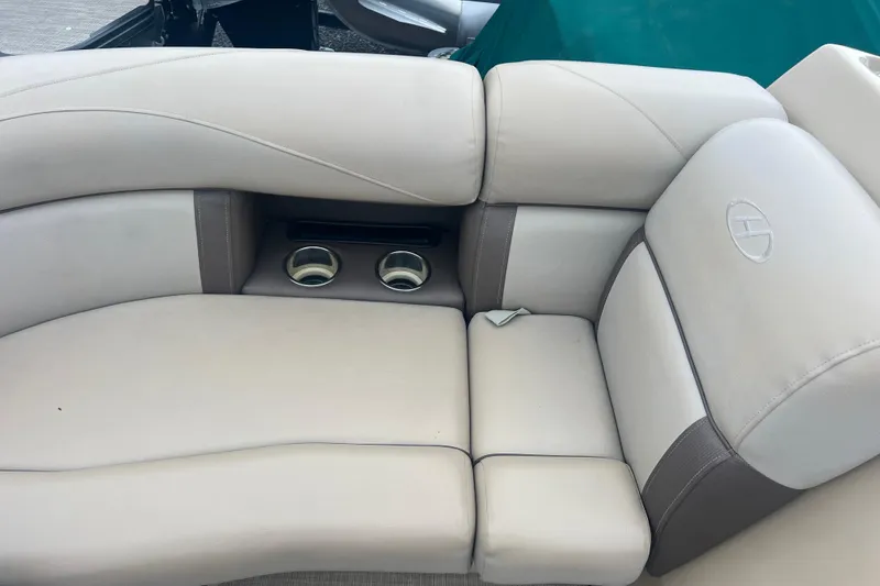 Slide: The Image of 2019 Harris Cruiser 210 boat interior with beige seating and cup holders. - 35