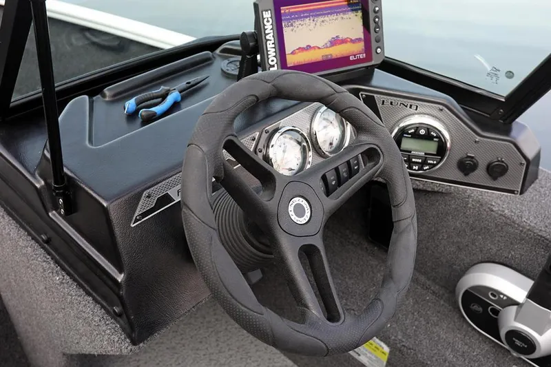 Slide: The Image of Manufacturer Provided Image: 2025 Lund 1650 Rebel XL Sport boat dashboard with steering wheel and navigation system. - 3