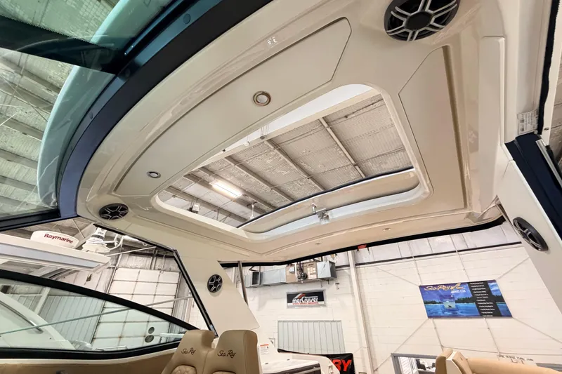 Slide: The Image of Interior view of 2026 Sea Ray Sundancer 320 Coupe with sunroof and speakers. - 10