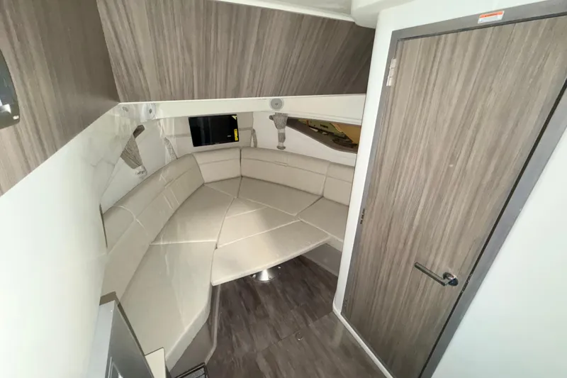 Slide: The Image of Interior of 2026 Sea Ray Sundancer 320 Coupe, featuring a cozy seating area. - 15