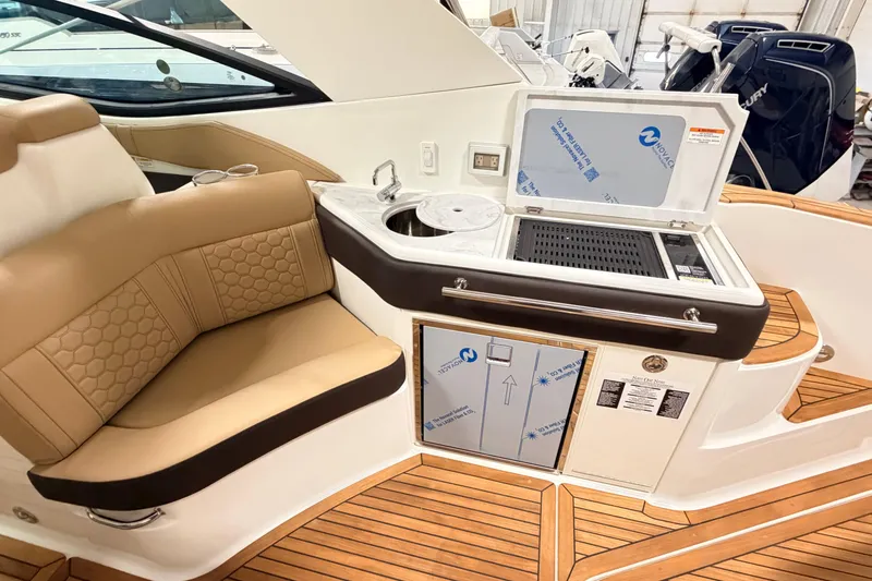 Slide: The Image of Luxurious interior of 2026 Sea Ray Sundancer 320 Coupe with seating and kitchenette. - 7