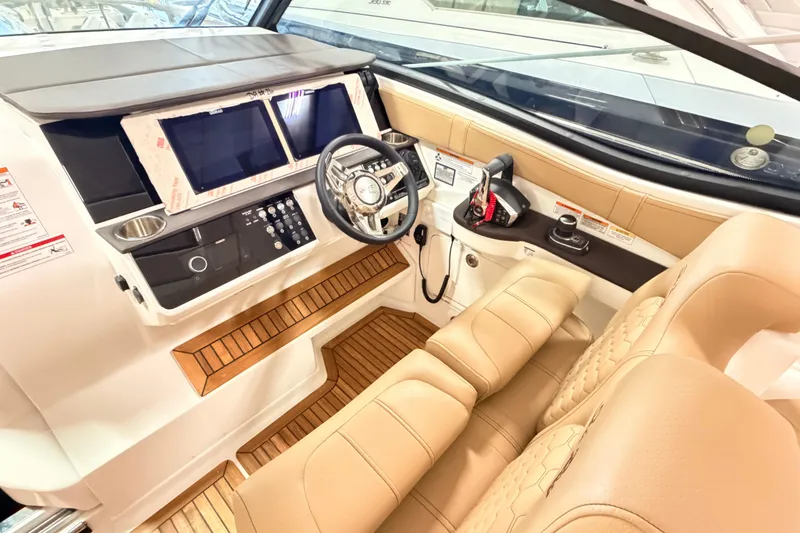 Slide: The Image of 2026 Sea Ray Sundancer 320 Coupe cockpit with modern controls and luxurious seating. - 8