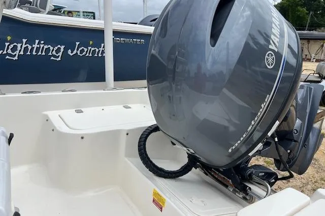Slide: The Image of 2024 Key West 1720 Center Console boat with Yamaha outboard motor, docked outdoors. - 4