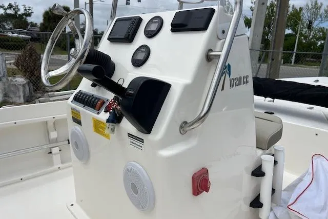 Slide: The Image of 2024 Key West 1720 Center Console boat dashboard with steering wheel and controls. - 7