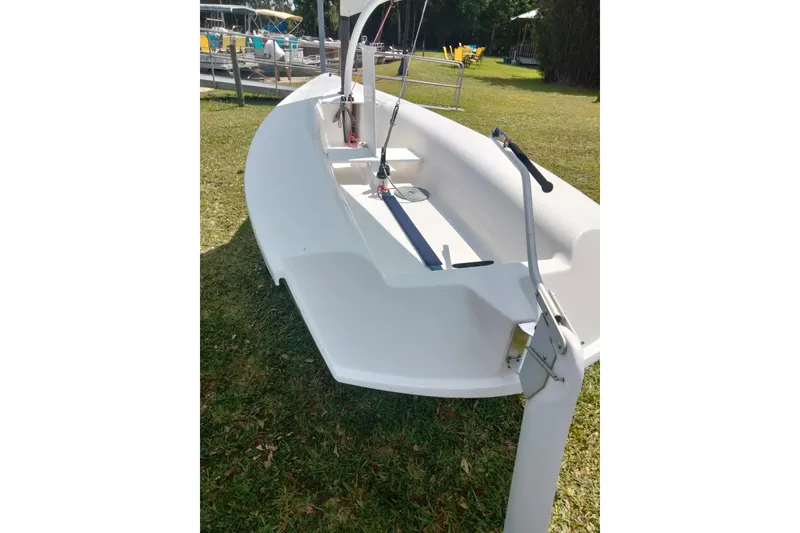 Slide: The Image of 2014 Catalina 12.5 Expo sailboat on grass, showcasing sleek design and modern features. - 10