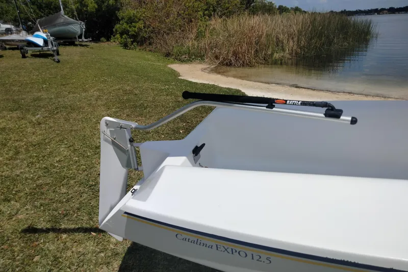 Slide: The Image of Catalina 12.5 Expo sailboat on grassy shore near lake, 2014 model. - 11