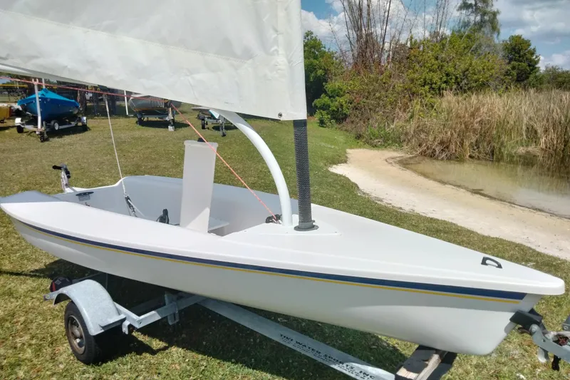 Slide: The Image of Sailboat Catalina 12.5 Expo 2014 on trailer by lakeside, ready for sailing. - 9