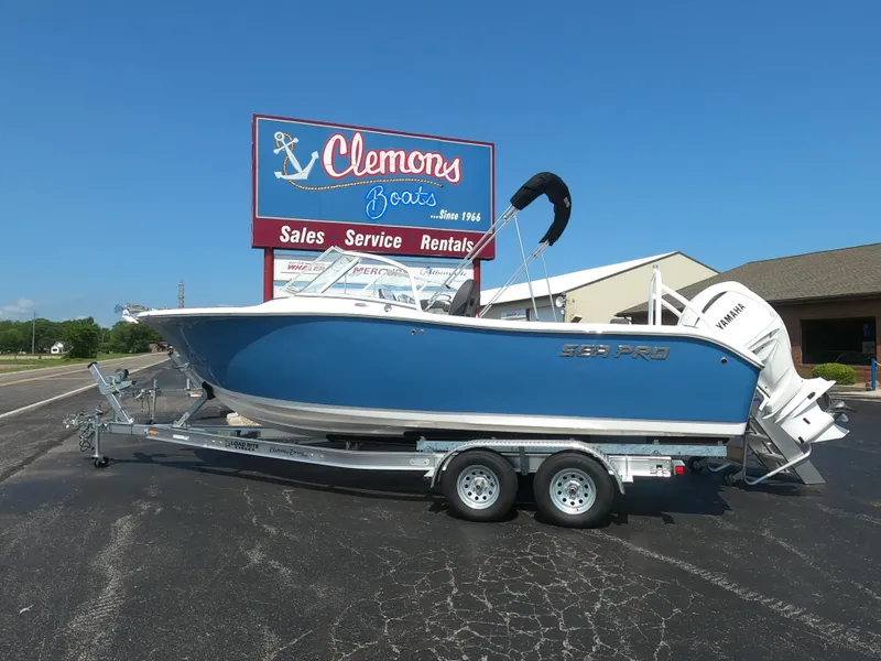 Slide: The Image of 2024 Sea Pro 240 Dual Console boat displayed outdoors on a trailer. - 1