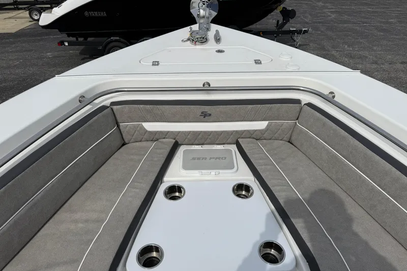 Slide: The Image of 2024 Sea Pro 240 Dual Console boat interior with cushioned seating and cup holders. - 20