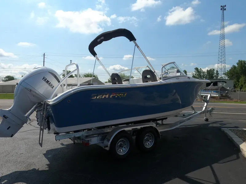 Slide: The Image of 2024 Sea Pro 240 Dual Console boat displayed between two other boats. - 5