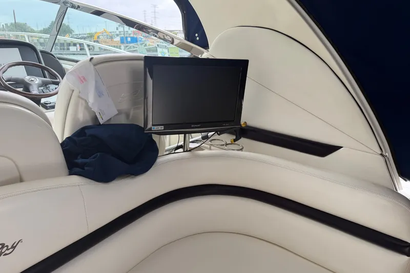 Slide: The Image of 2008 Sea Ray 380 Sundancer helm with gauges and storage compartment. - 10