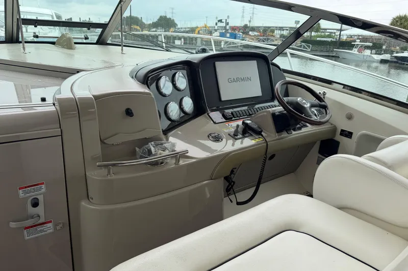 Slide: The Image of Control panel of a 2008 Sea Ray 380 Sundancer with warning labels and communication device. - 16
