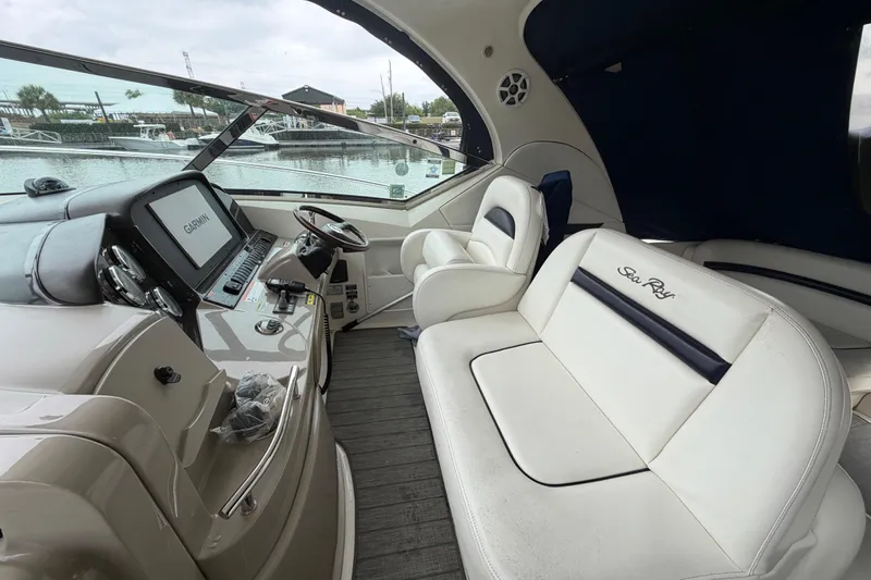 Slide: The Image of Interior of 2008 Sea Ray 380 Sundancer with white leather seating and steering area. - 18