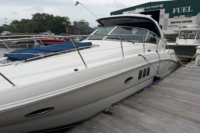 Slide: The Image of 2008 Sea Ray 380 Sundancer yacht docked at marina with service center in background. - 2
