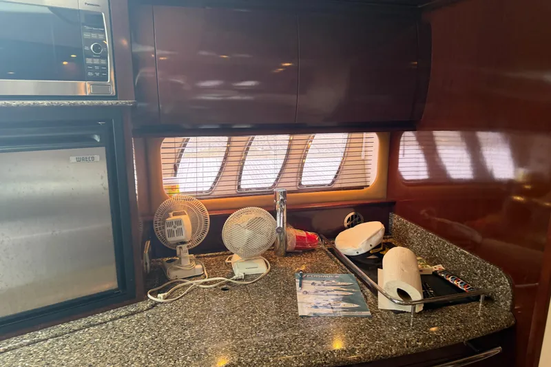 Slide: The Image of Interior of 2008 Sea Ray 380 Sundancer with microwave, fridge, and countertop accessories. - 26