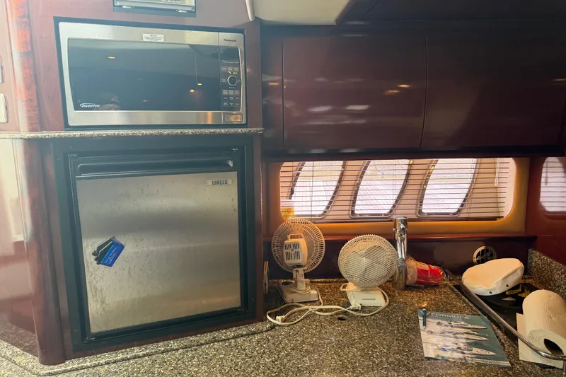 Slide: The Image of Control panel on 2008 Sea Ray 380 Sundancer yacht with wood finish and granite countertop. - 27