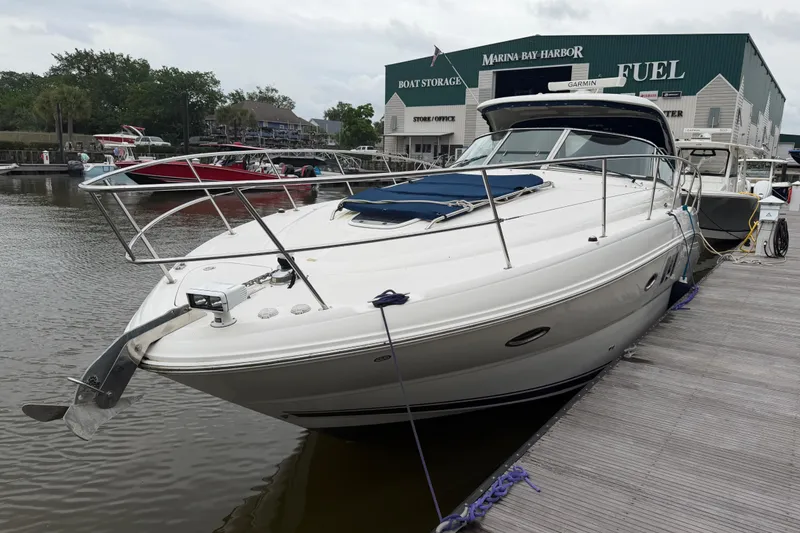 Slide: The Image of 2008 Sea Ray 380 Sundancer docked at marina, front view with anchor visible. - 3