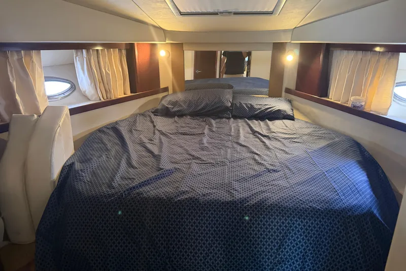 Slide: The Image of Interior cabin view of a 2008 Sea Ray 380 Sundancer yacht, featuring a cozy bed. - 30
