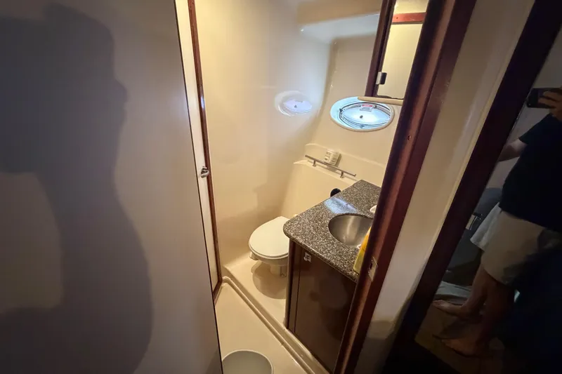 Slide: The Image of Shower area in 2008 Sea Ray 380 Sundancer yacht with wooden seat and porthole windows. - 32