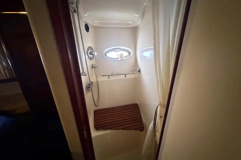 Slide: The Image of Interior cabin of 2008 Sea Ray 380 Sundancer with bed and porthole window. - 33