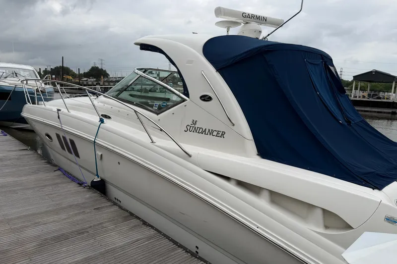 Slide: The Image of 2008 Sea Ray 380 Sundancer yacht docked with blue cover, overcast sky. - 4