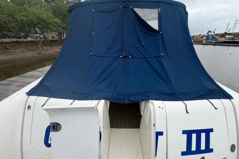 Slide: The Image of Interior of 2008 Sea Ray 380 Sundancer with white seating and blue canopy. - 6