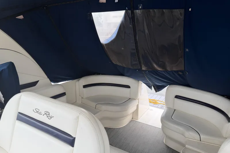 Slide: The Image of 2008 Sea Ray 380 Sundancer interior with white seating and blue canopy. - 7