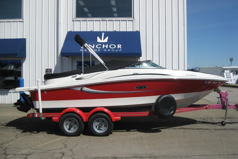 Slide: The Image of 2008 Sea Ray 195 Sport boat on trailer outside Anchor Marine Group building. - 1