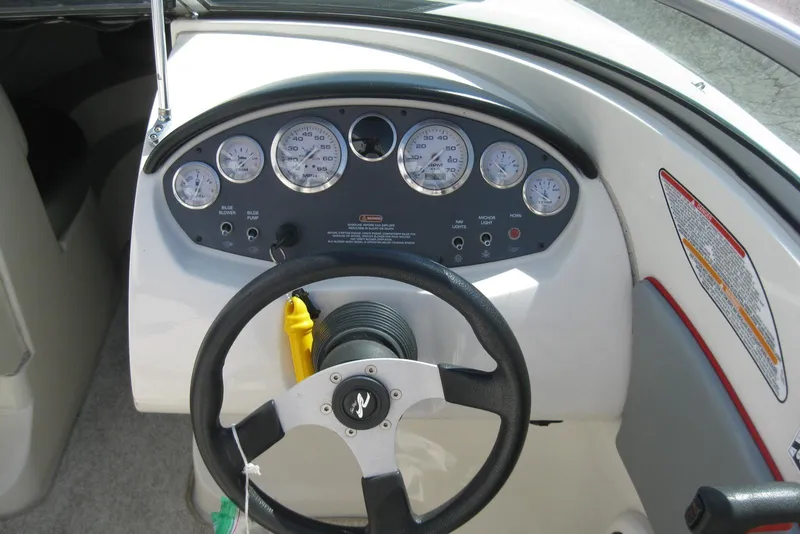 Slide: The Image of Dashboard of a 2008 Sea Ray 195 Sport boat with steering wheel and gauges. - 13