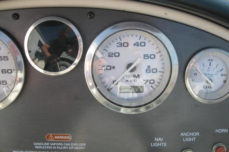 Slide: The Image of Dashboard of a 2008 Sea Ray 195 Sport boat showing RPM and oil gauges. - 14