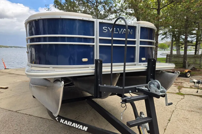Slide: The Image of 2016 Sylvan Mirage Cruise 8522 LZ pontoon boat on trailer by lakeside. - 1