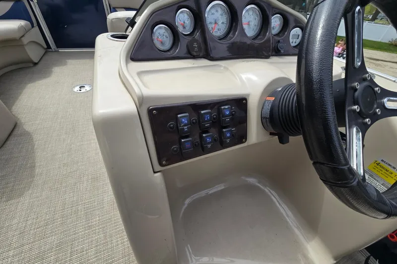 Slide: The Image of 2016 Sylvan Mirage Cruise 8522 LZ dashboard with steering wheel and control panel. - 12