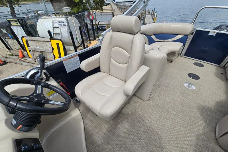 Slide: The Image of 2016 Sylvan Mirage Cruise 8522 LZ interior with beige seating and steering wheel. - 17