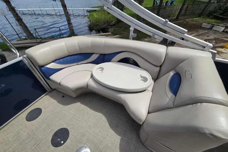 Slide: The Image of 2016 Sylvan Mirage Cruise 8522 LZ pontoon boat with beige and blue seating, lake view. - 19