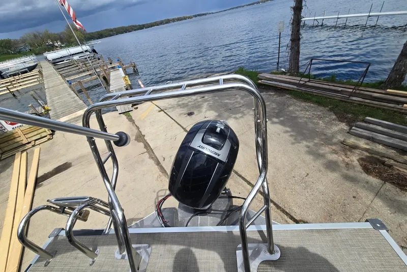 Slide: The Image of 2016 Sylvan Mirage Cruise 8522 LZ pontoon boat docked by a scenic lake. - 21