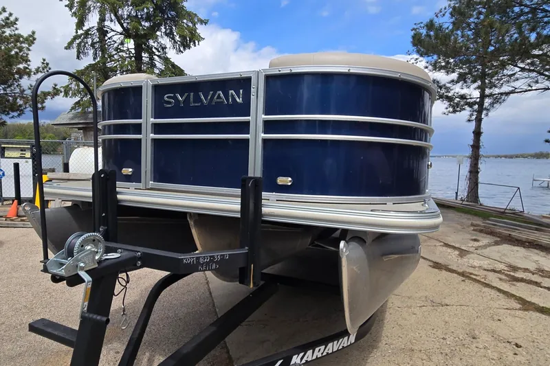 Slide: The Image of 2016 Sylvan Mirage Cruise 8522 LZ pontoon boat on trailer by a lake. - 9
