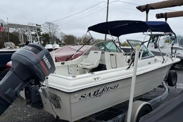 Slide: The Image of 2001 Sailfish 198 DC boat with Yamaha outboard motor on trailer, parked outdoors. - 11