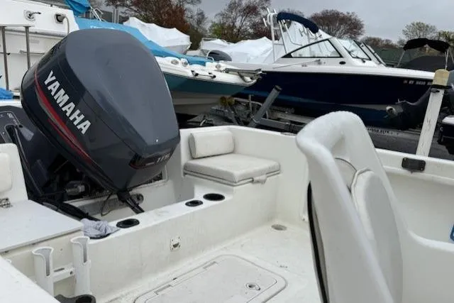 Slide: The Image of 2001 Sailfish 198 DC boat with Yamaha outboard motor, docked among other boats. - 4