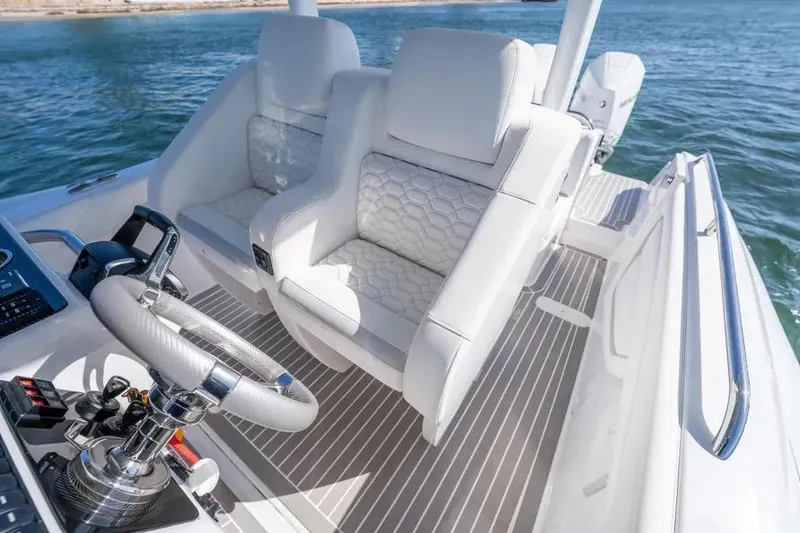 Slide: The Image of Luxurious white seating on 2025 Airship 340 boat, featuring modern steering and controls. - 8