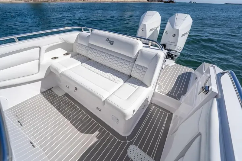 Slide: The Image of Luxurious seating on 2025 Airship 340 boat with twin Mercury engines, cruising on open water. - 9