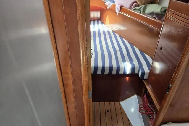 Slide: The Image of Interior cabin of 2002 Beneteau First 36.7 sailboat with striped bedding. - 11