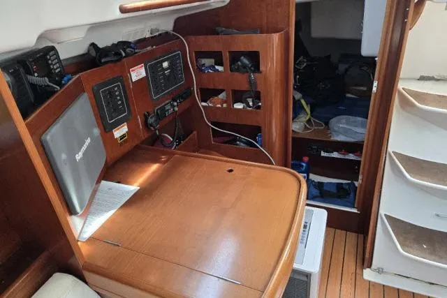 Slide: The Image of Interior of 2002 Beneteau First 36.7 sailboat with navigation station and storage. - 12