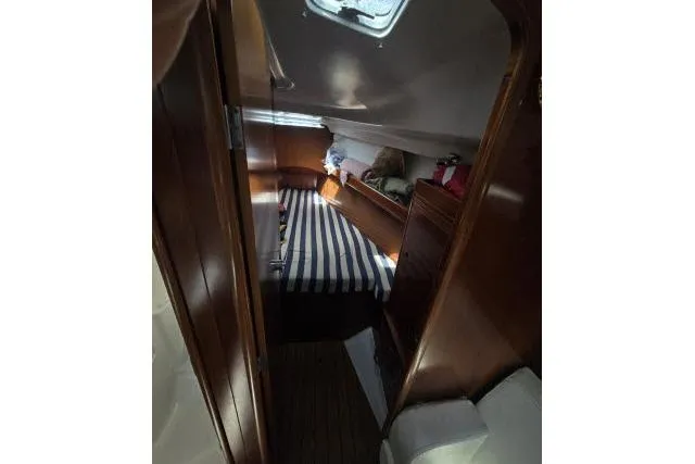 Slide: The Image of Cozy cabin interior of 2002 Beneteau First 36.7 sailboat with striped bedding. - 14