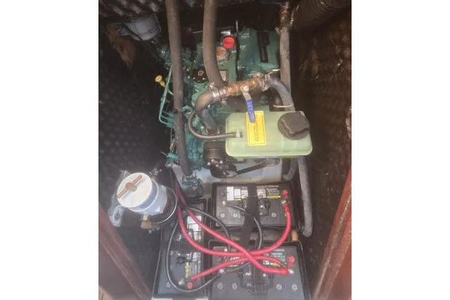 Slide: The Image of Engine compartment of a 2002 Beneteau First 36.7 sailboat, featuring batteries and wiring. - 15